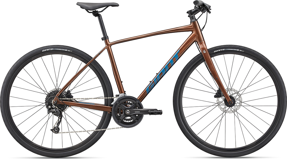 Brown flat bar road bike with the brand Giant written on the frame in blue