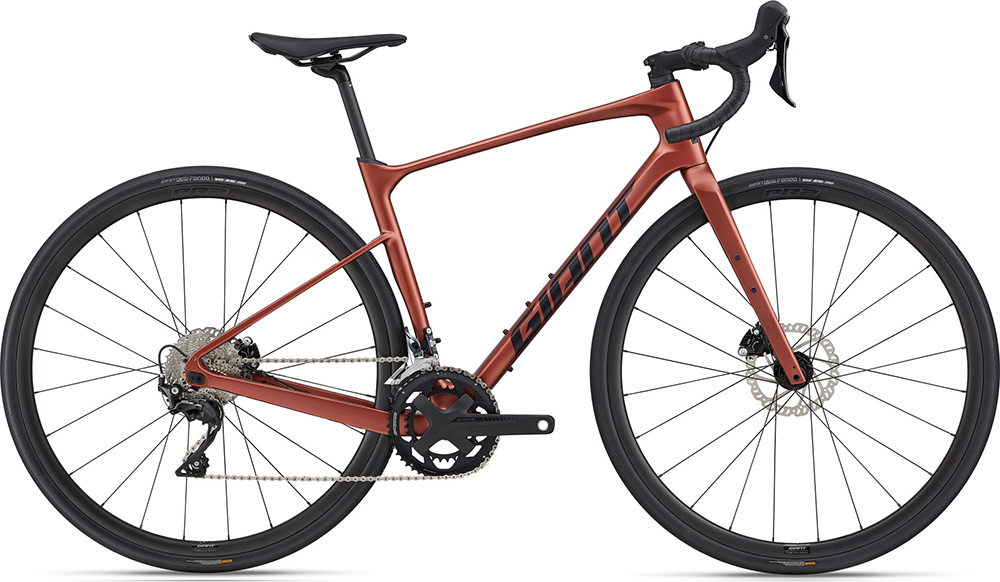Red carbon road bike with the brand Giant written on the frame